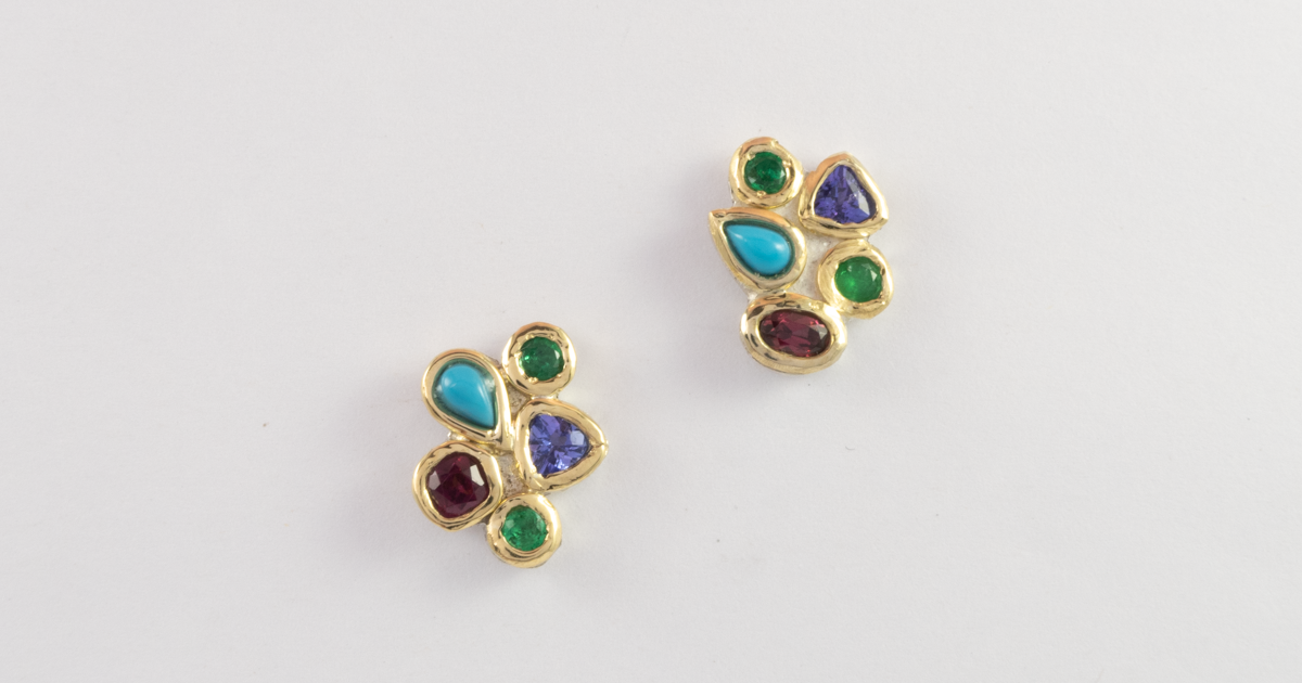 Matching birthstone earrings with Tanzanite, Emerald and Garnet desktop image