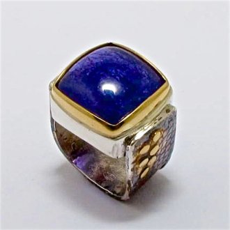 A Handmade Sterling Silver and 18ct Yellow Gold RING set with Tanzanite (18.8cts.). Gold mass 2 gms.