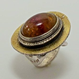 A Handmade Sterling Silver and 18ct Yellow Gold RING set with Oval Cabochon Tourmaline (26.4cts.). Gold mass 1.5gms.