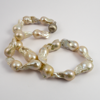 A NECKLACE of White XL Baroque Freshwater Pearls on Silver Clasp.