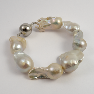 A BRACELET of White XL Baroque Freshwater Pearls on Silver Clasp.