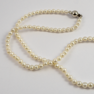 A NECKLACE of White Freshwater Pearls on Sterling Silver Clasp. 4mm Diameter.
