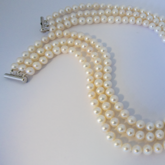 A 3-Row NECKLACE of Round White Freshwater Pearls on Sterling Silver Clasp.