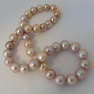 A NECKLACE of Natural off-Round Freshwater Pearls on Rose Gold Clasp. 11-14mm Diameter.