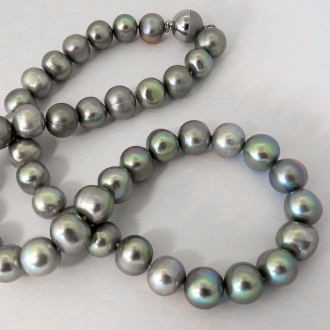 A NECKLACE of Grey off-Round Freshwater Pearls on Silver Magnetic Clasp. 10.5-11.5mm Diameter.