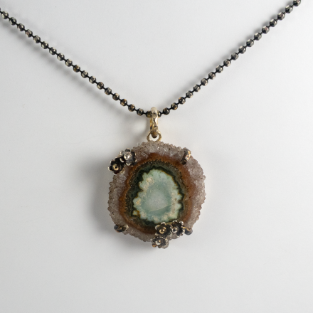 A thoughtful and caring gift - combining symbolic daisies and rare solar quartz centre stone.