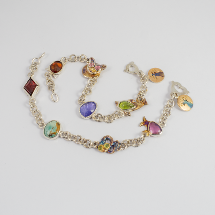 A Pair of Bracelets with all the birthstones and handmade elements reflecting each one's favourite object.