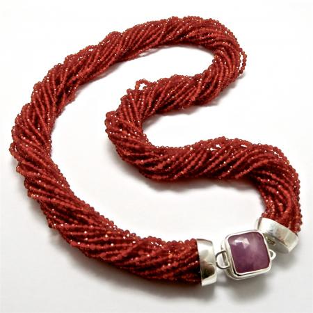 A NECKLACE of Carnelian with Handmade Sterling Silver and Pink Sapphire Clasp.