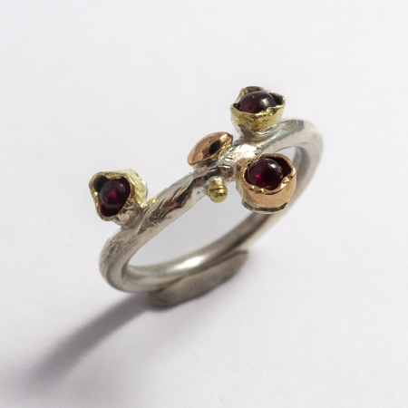 A Handmade Sterling Silver, Rose and Green Gold RING set with Rubies. Gold mass 0.50 gms.