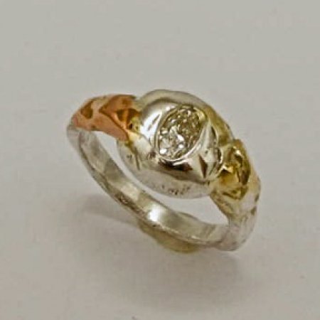A Handmade Fine Silver and 18ct Rose Gold RING set with Oval Diamond. (0.414cts.) M; VVS2. Gold mass 09gms