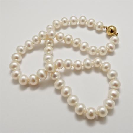 A NECKLACE of White Off-Round Freshwater Pearls on 9ct gold Ball Clasp.
