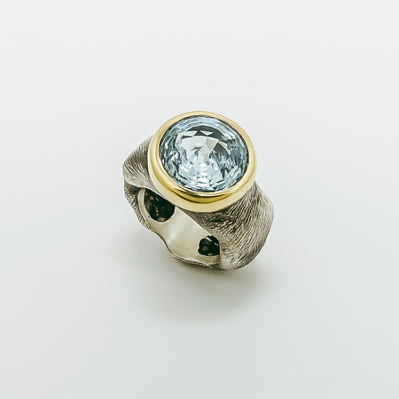 A Handmade Sterling Silver and 9ct Gold RING set with Mystic-cut Aquamarine.