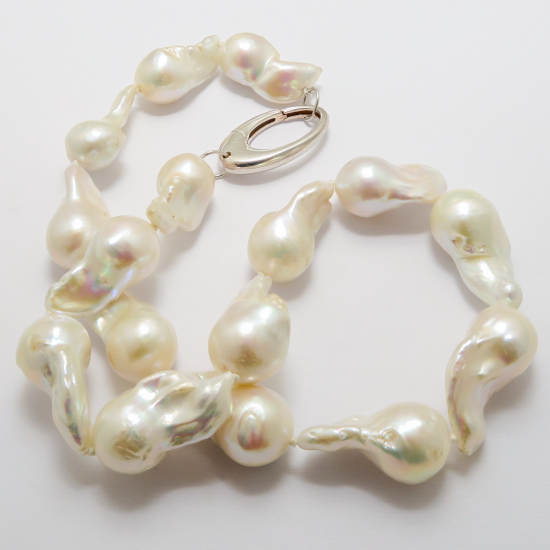 A NECKLACE OF White Baroque Freshwater Pearls on Sterling Silver Clasp.