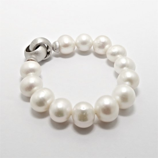 A BRACELET of Off-Round Freshwater Pearls on Sterling Silver Clasp.
